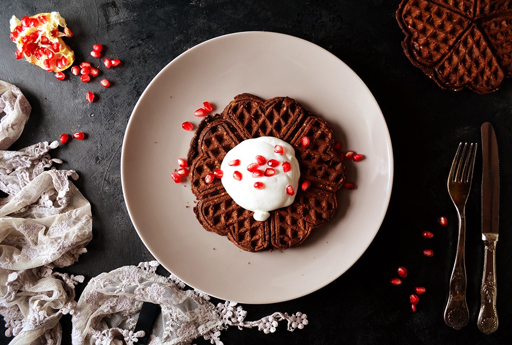 chocolate waffle with cream and pomegranate seeds