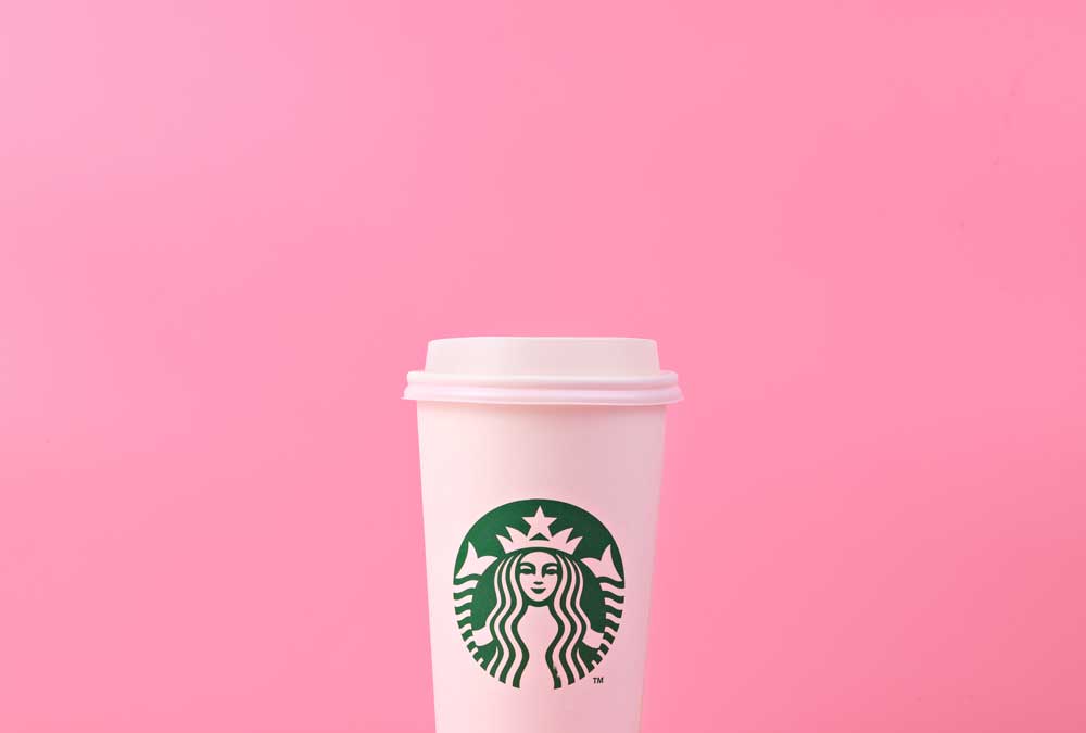starbucks cup on pink background