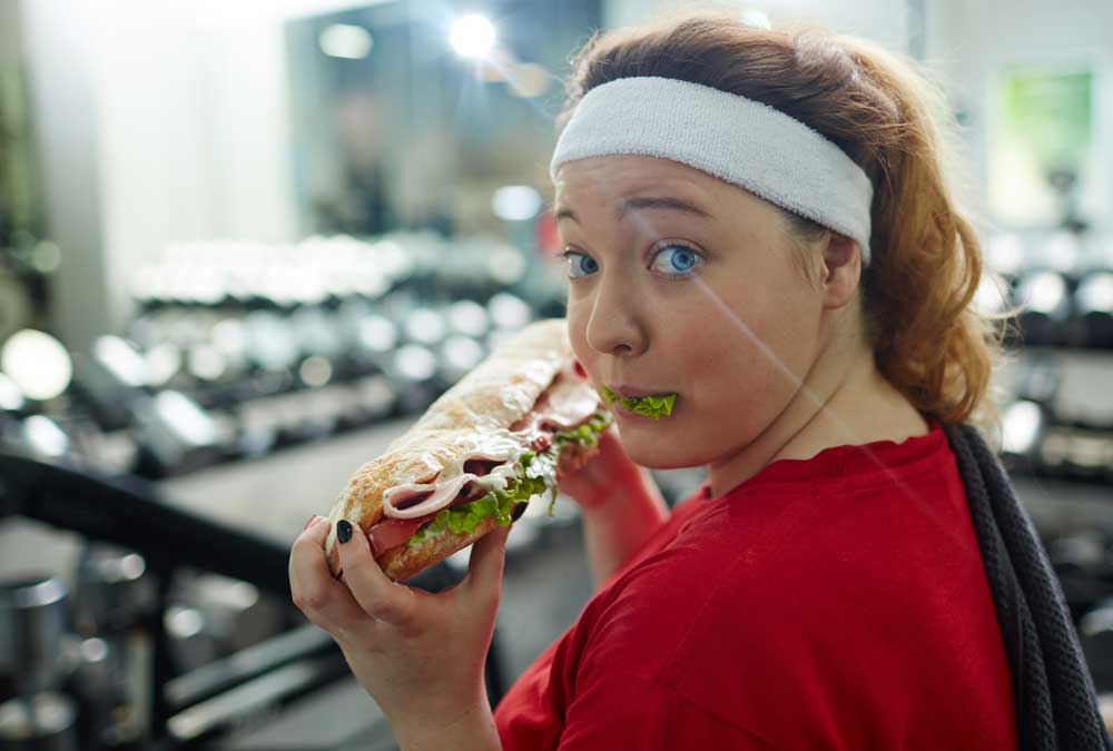 lady eat a sandwich instead of working out