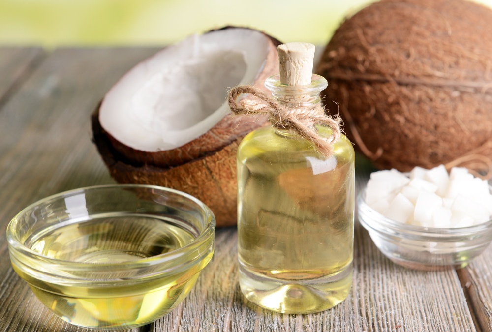 bottle of mct oil and coconuts