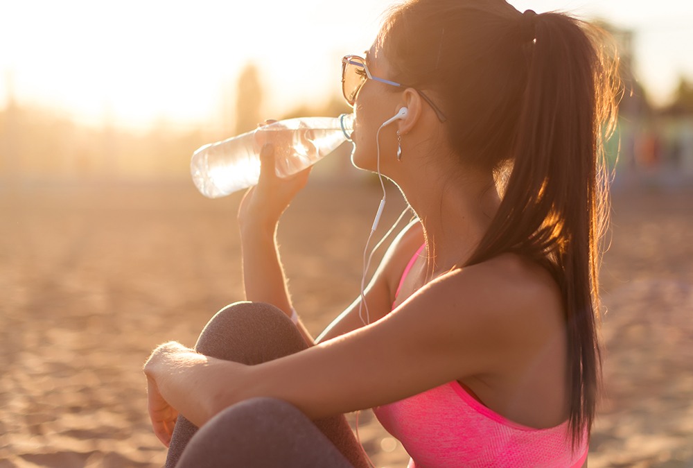 woman sungazing and drinking water