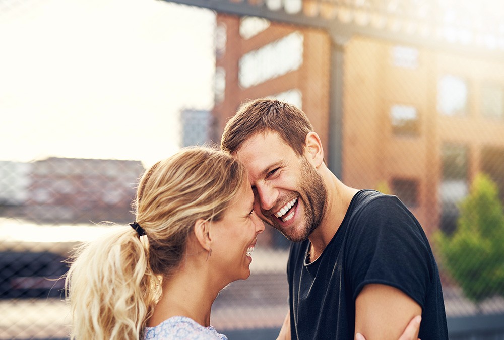 smiling couple touching foreheads